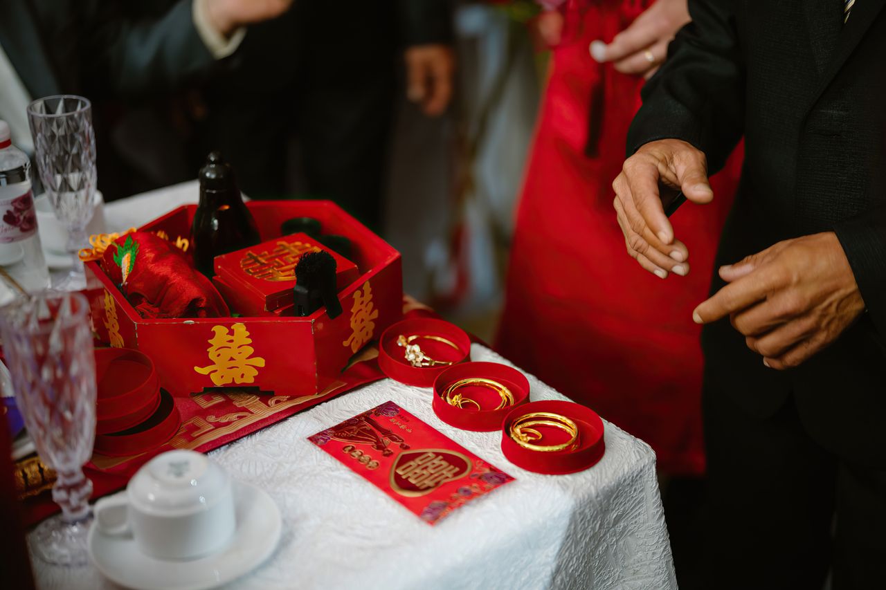 services-03 Red gift boxes and gold jewelry at a Vietnamese wedding ceremony in Ho Chi Minh City.